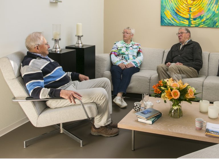 Drie personen in een huiskamersetting